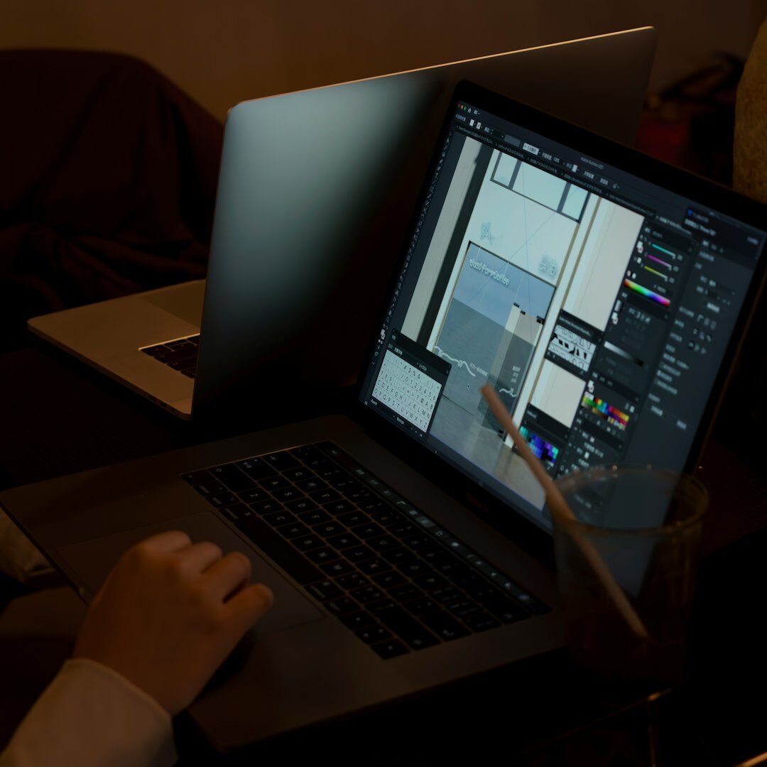Video editor working on multiple monitors in a modern studio